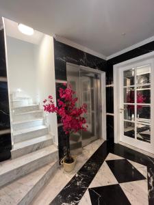 a lobby with stairs and a potted plant at Torri Studios in Sliema +12 photos