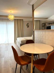 a room with a table and chairs and a bed at Torri Studios in Sliema