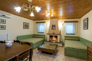 a living room with green furniture and a fireplace at Rodami in Kalentzi