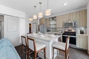 a kitchen with a table and chairs in a room at Texas Two Step by 30A Escapes in Rosemary Beach
