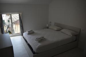 Postel nebo postele na pokoji v ubytování Vittoria Apartments