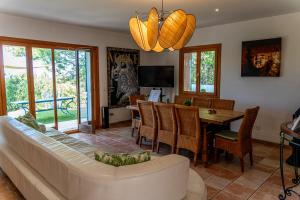 a living room with a couch and a dining room at VILLA SOFIA in Valldemossa