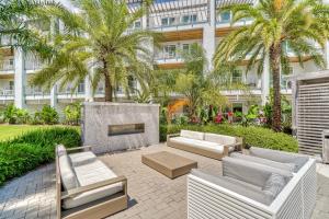 a patio with couches and a fireplace in front of a building at The Pointe Unit 321 by 30A Escapes in Rosemary Beach