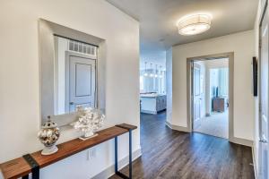 a living room with a table and a mirror at The Pointe Unit 321 by 30A Escapes in Rosemary Beach