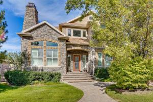 uma casa de pedra com uma chaminé de tijolos e uma entrada para carros em Upscale Group Getaway in Orem with Private Hot Tub em Orem