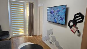 a living room with a flat screen tv on a wall at Citycentre - Sebastian in Budapest