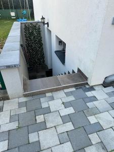 a building with a stairway with a green wall at Les Mirabelles in Ensisheim