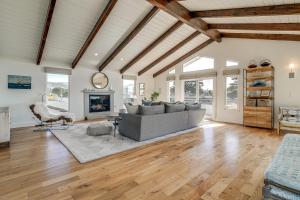 a living room with a couch and a fireplace at Walk to Ocean Luxe Family Home in Half Moon Bay! in Half Moon Bay