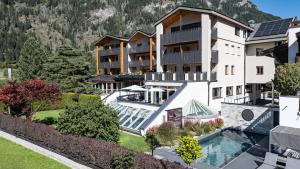 an aerial view of a resort with a swimming pool at Hotel WH - Wiesnerhof in Vipiteno