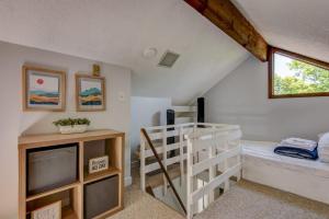 a attic room with a bunk bed and a ladder at Top Of Seven in Seven Devils