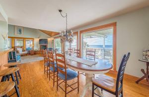 a dining room with a table and chairs at Family Tradition - Duck, Sanderling, Soundfront, Private Pier, Sunset Views, Community Pool, Pets OK in Duck