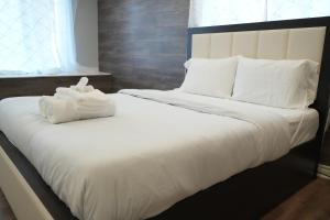 a bed with two white towels on top of it at Poolside Retreat with Private Patio in Brampton +68 photos