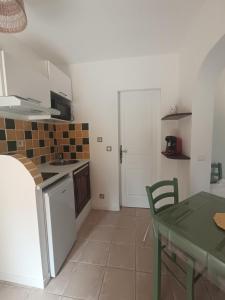 a kitchen with a table and a table and a table and a kitchen with at villa Léonfine in Le Cannet-des-Maures +10 photos