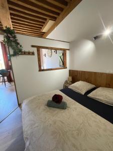 a bedroom with a bed with a red hat on it at Chaleureux studio - Centre ville in Paray-le-Monial