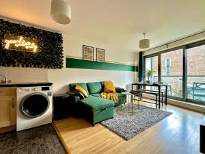 ein Wohnzimmer mit einem Sofa und einer Waschmaschine in der Unterkunft Watford Serviced Apartment, Free Parking, City Centre Sleeps 5 in Watford