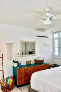 a bedroom with a bed and a dresser with a mirror at Fajardo Oceanfront - Marina Views, Wi-Fi & Pool in Beltran