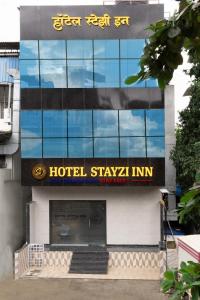 a hotel stayka inn sign on the side of a building at Hotel Stayzi Inn in Navi Mumbai
