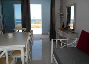 a kitchen and dining room with a table and chairs at Petrakis sunset in Palaiochora