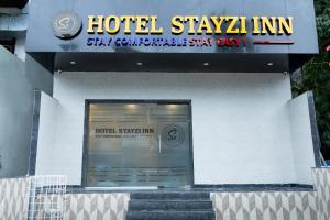 a hotel sign on the side of a building at Hotel Stayzi Inn in Navi Mumbai