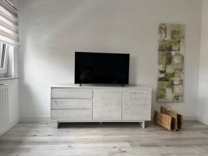 a television sitting on top of a dresser in a room at Gemütlich wohnen in Brake in Bielefeld