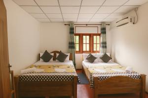 a room with two beds and a window at Sun Reich - Airport Transit Hotel in Katunayaka +22 photos