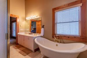 a bathroom with a tub and two sinks and a window at Ambleside in Vilas +42 photos