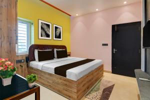 Ένα ή περισσότερα κρεβάτια σε δωμάτιο στο Hotel O PALLAVI INN