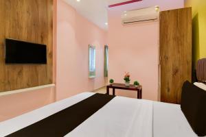 Ένα ή περισσότερα κρεβάτια σε δωμάτιο στο Hotel O PALLAVI INN