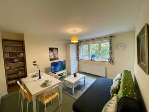 a living room with a couch and a table at Family Friendly 3 Bedrooms Flat in Central London in London