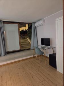 a living room with a desk and a chair and a window at La Dimora di Vittorio Emanuele II in Barletta