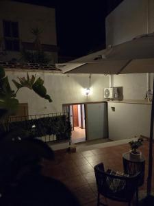 a view of a patio at night with an umbrella at La Dimora di Vittorio Emanuele II in Barletta