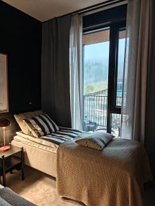 a bedroom with a bed and a large window at Levi Fjällen 6 in Levi