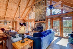 a living room with a blue couch and a fireplace at Fox's Lair in Sugar Grove