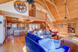 a living room with blue furniture and a wooden ceiling at Fox's Lair in Sugar Grove
