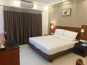 Ένα ή περισσότερα κρεβάτια σε δωμάτιο στο Hotel O Thumba Beach Trivandrum
