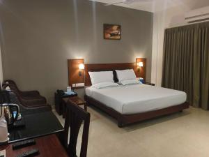 Ένα ή περισσότερα κρεβάτια σε δωμάτιο στο Hotel O Thumba Beach Trivandrum