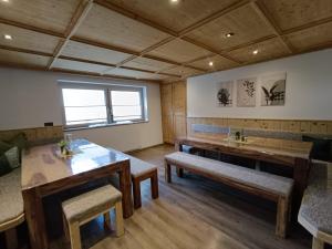 a room with wooden tables and benches and a window at Appartement Catrin mit Sauna und E-Ladestation in Ried im Zillertal