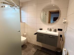 a bathroom with a sink and a mirror at Appartement Catrin mit Sauna und E-Ladestation in Ried im Zillertal