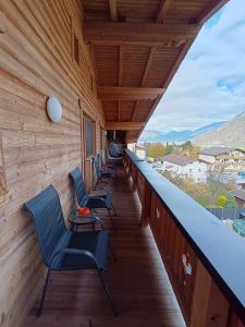 a row of chairs sitting on a balcony at Appartement Catrin mit Sauna und E-Ladestation in Ried im Zillertal