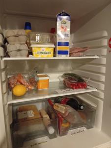 an open refrigerator filled with lots of food at B&BAnjanaS in Vaggeryd