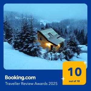 a log cabin in the snow with lights on at ALMNEST - LACHTAL in Lachtal
