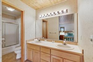 a bathroom with two sinks and a toilet and a mirror at Beaverhead 1421 in Big Sky +22 photos