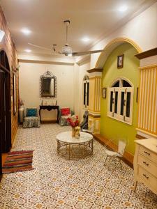 a living room with a table and a couch at Sajjan Niwas - A Luxury Homestay in Jodhpur