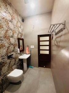 a bathroom with a toilet and a sink at Sajjan Niwas - A Luxury Homestay in Jodhpur
