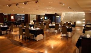 a dining room with tables, chairs, and tables in it at Ros Tower Hotel in Rosario