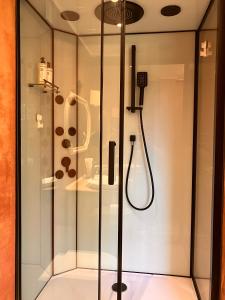 a shower in a glass case in a room at Li Amber Apartment Carnikava in Carnikava +40 photos