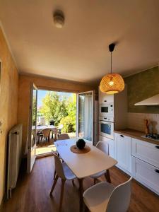 a kitchen and dining room with a table and chairs at La Vernoisienne dans le Jura in Le Vernois