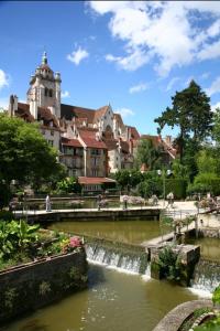a bridge over a river in a city with buildings at La Vernoisienne dans le Jura in Le Vernois +28 photos