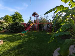 a playground with a slide in a yard at Ohana in Zárate