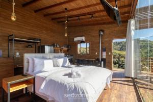 a bedroom with a bed with a teddy bear on it at Cabana c/ vista panorâmica e jacuzzi - VST026 in São Paulo dos Pinhais